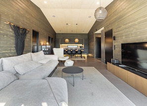 A modern living room with a sofa, a coffee table, and a TV. - Villa Noel B (Lappi)