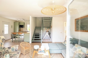 A modern living space with a kitchen, dining area, and a cozy seating area with a sofa and chairs. - Tamariu - Magnificent villa with swimming pool (CT)