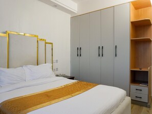 Ein Schlafzimmer mit Bett, Kleiderschrank und Nachttisch.