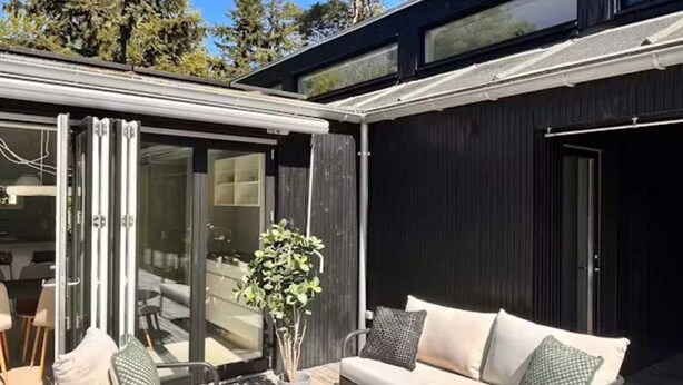 A modern outdoor patio with a sofa, chairs, and a table. - 4 Star Holiday Home in Nykobing Sj (Nykobing Sjaelland)