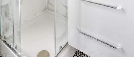 Shower, hair dryer, towels, toilet paper