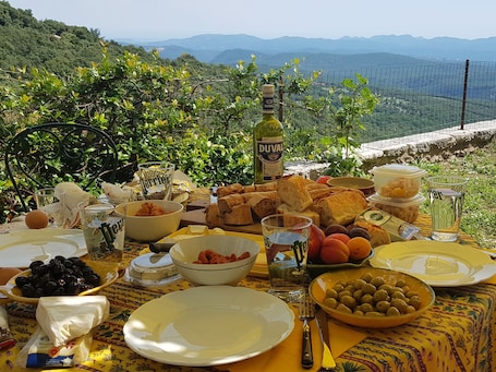 Outdoor dining. L'Oustau Le Logis - authentic family home with sea view and lush garden