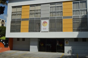 A building with a modern design, featuring a prominent logo and signage indicating it is a MARE property.