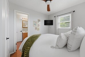 A bedroom with a bed, a ceiling fan, a television, and a window with blinds. - Secluded Cabin w/ Hot Tub & Stunning Mountain (Sevierville)