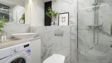 Shower, hair dryer, towels, shampoo
