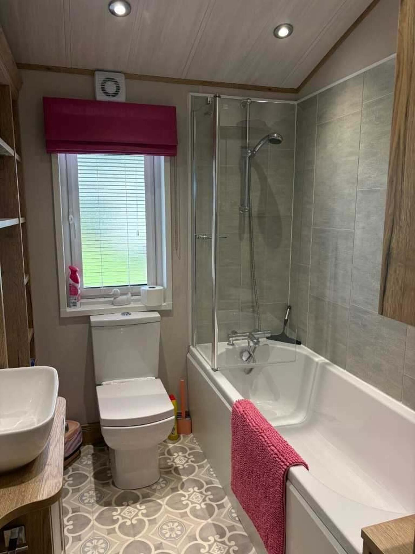 A bathroom with a toilet, sink, bathtub, and shower.