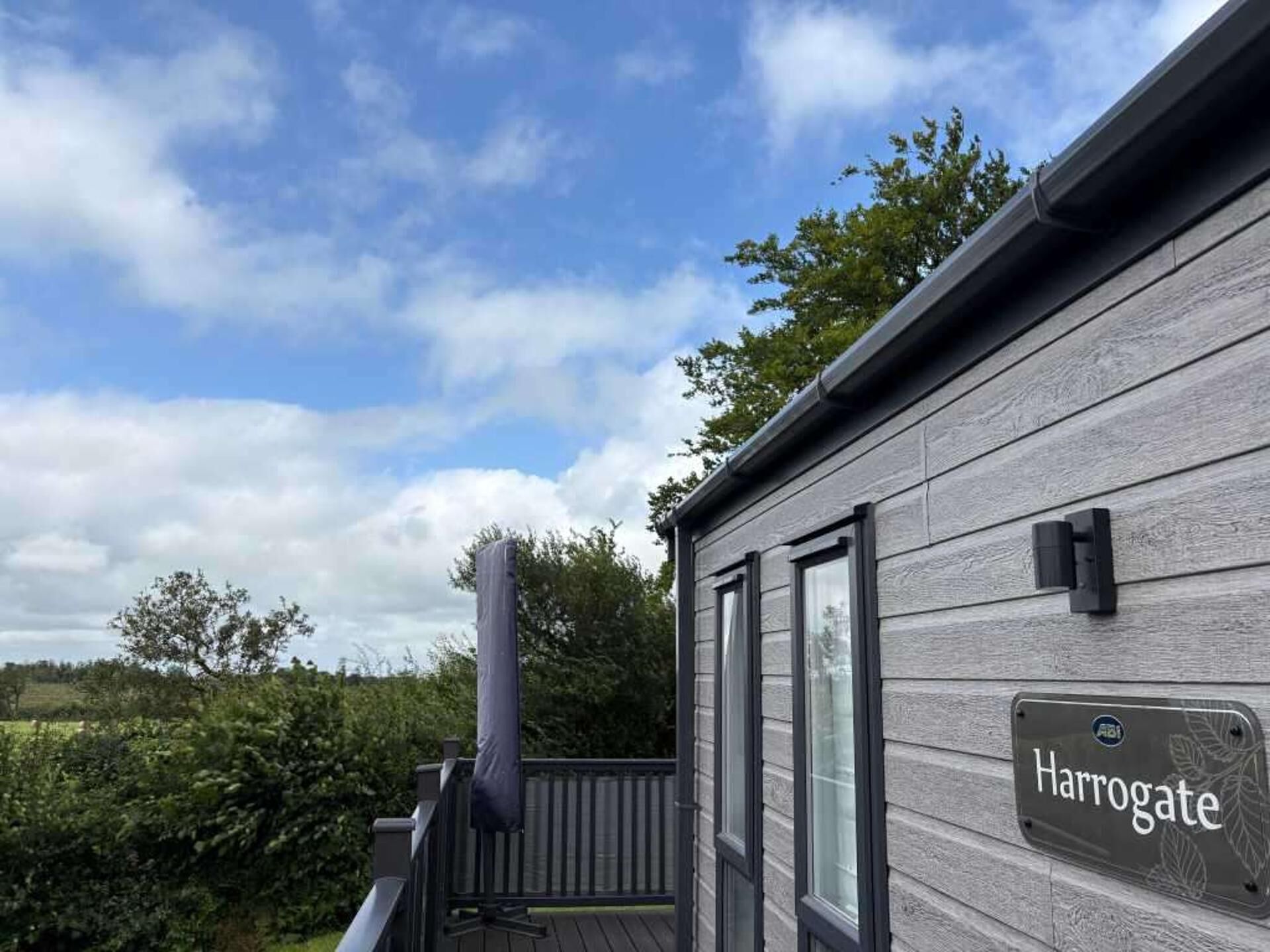 A wooden exterior wall with a sign reading 'Harrogate.'