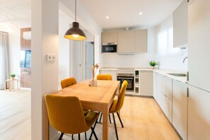 A modern kitchen with white cabinets, a built-in oven, and a microwave. - 100 m from the Beach - Downtown Sitges | Sebas by PG (Sitges)