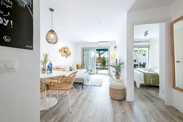 A modern interior with a dining area, a living space, and a bedroom. - Modern Apartment w/ big Patio | Maria by Palmera (Sant Pere de Ribes)
