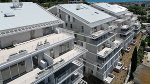 A modern multi-story residential building with balconies, large windows, and a flat roof. - Apartment with AC, parking - 4 guests (Sète)