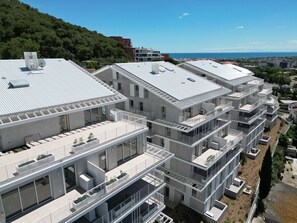 A modern multi-story residential building with balconies, large windows, and a flat roof. - Apartment with AC, parking - 4 guests (Sète)