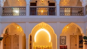 A multi-level interior with arched doorways, a central seating area, and a balcony with ornate railings. - Riad Dar Noa Marrakech (Marrakech)