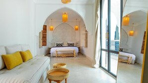 A room with a bed, a sofa, and a large window. - Riad Dar Noa Marrakech (Marrakech)