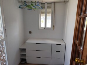 A white closet with a window, a shelf, and a door. - Comfortable house with AC - 10 guests (Granada)