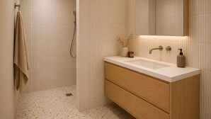 A modern bathroom with a shower, a vanity with a mirror, and a towel rack. - Apartment 'L'instant Vercors, Balcon Des Cimes' with Mountain View, Balcony and Wi-Fi (Villard-de-Lans)