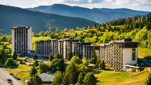 A residential complex with multiple high-rise buildings, surrounded by lush greenery and mountains in the background. - Apartment 'L'instant Vercors, Balcon Des Cimes' with Mountain View, Balcony and Wi-Fi (Villard-de-Lans)