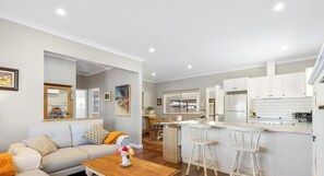 A modern apartment with a living room, kitchen, and dining area.