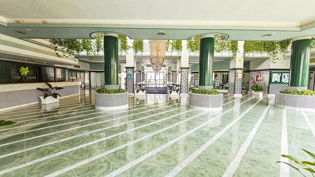 A spacious lobby with a marble floor, large columns, and potted plants. - Luxury studio, sea view in Tenerife (Playa Paraiso)