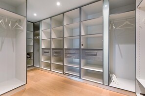 A walk-in closet with open shelving, drawers, and hanging space.