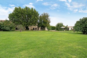 A grassy field with a building and trees. - Holiday Home "Bastide Neuve en Provence" with Private Pool, Terrace & Wi-Fi (Caumont-sur-Durance)