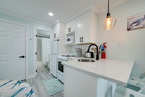 A modern kitchen with white cabinetry, a built-in microwave, a stove, and a sink. - 2 Block to Beach & Boardwalk! Wildwood Studio (Wildwood)