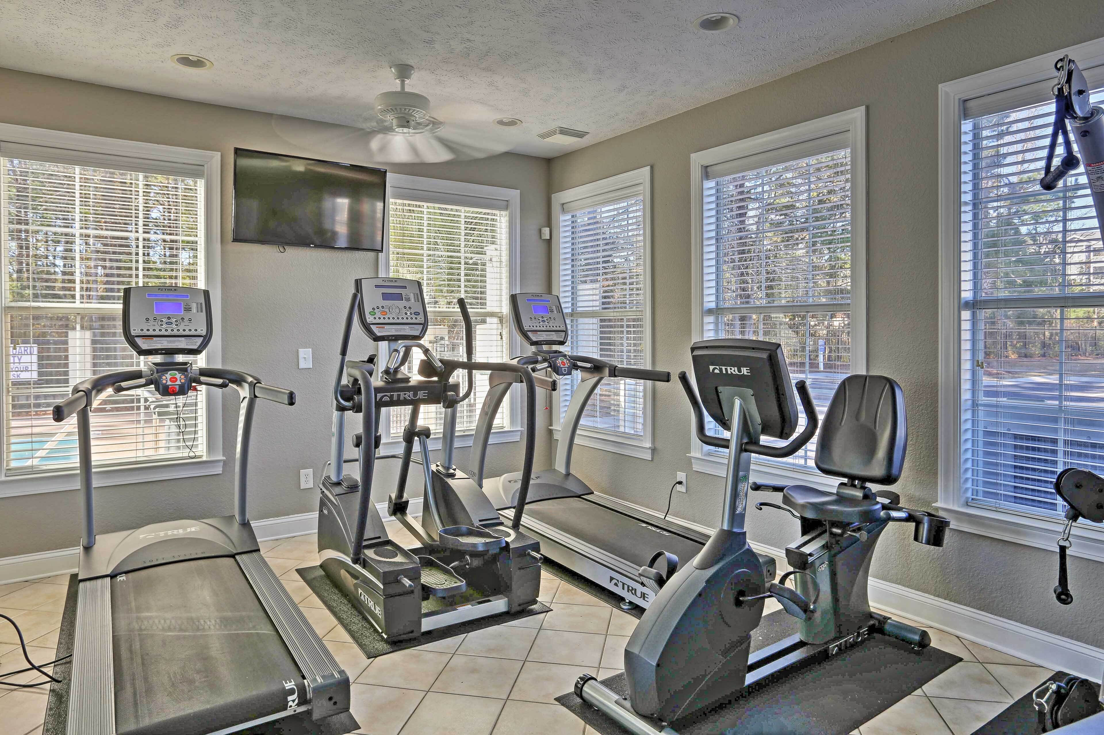 A home gym with treadmills, elliptical machines, and a stationary bike.