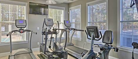 A home gym with treadmills, elliptical machines, and a stationary bike.