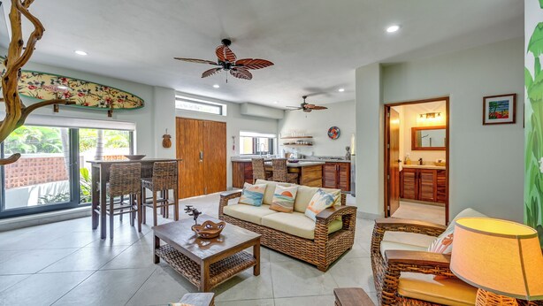 A spacious living area with wicker furniture, ceiling fans, and a view to the outside. - Walk to Beach & Dining! Chic San Pancho Casita (San Francisco)