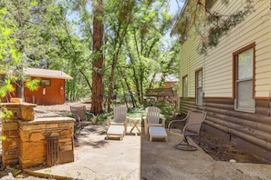 A cabin with a patio area, outdoor seating, and a stone fireplace. - Year-round Mtn Escape in the 'arizona Rockies' (Lakeside)