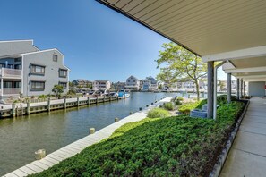A waterfront property with a dock, a canal, and adjacent buildings. - Bayfront Condo w/ Sunset Views! Walk to Beach (Seaside Heights)