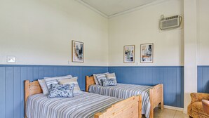 A room with two wooden beds, a chair, and two framed artworks on the wall. - Waterfront Studio w/ Dock, 8 Mi to Kemah Boardwalk (Dickinson)