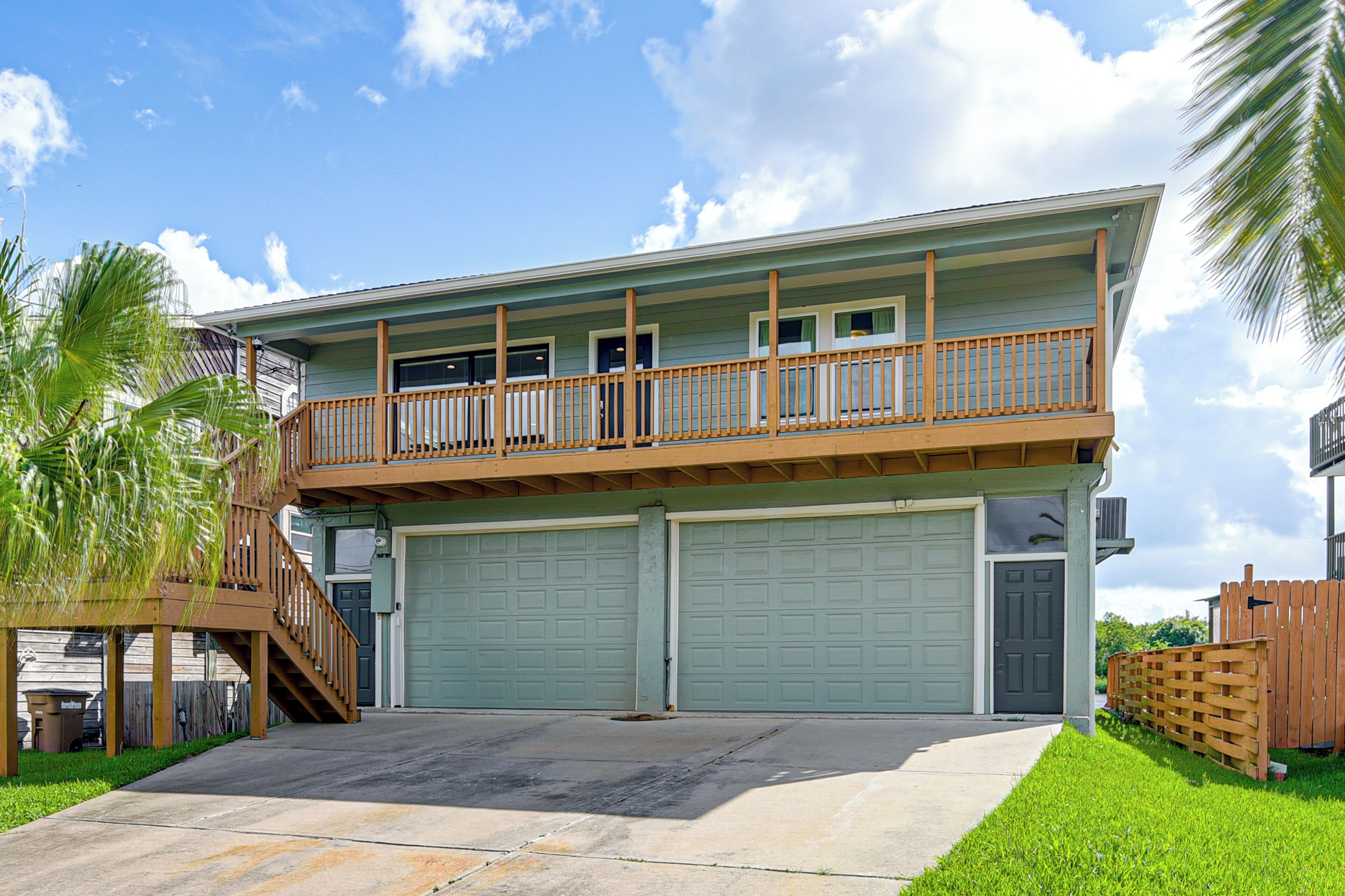 A two-story house with a balcony, a garage, and a staircase.