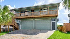 A two-story house with a balcony, a garage, and a staircase. - Waterfront Studio w/ Dock, 8 Mi to Kemah Boardwalk (Dickinson)