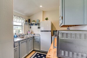 A kitchen with a refrigerator, microwave, sink, and cabinets. - Waterfront Studio w/ Dock, 8 Mi to Kemah Boardwalk (Dickinson)