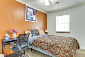 A bedroom with a bed, desk, chair, and a window. - Bring Your Pets! Family-friendly Escape in Edmond (Edmond)