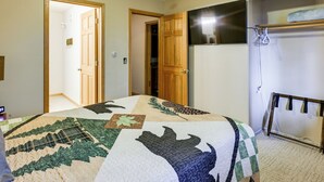A bedroom with a bed, a wardrobe, a mirror, and a door leading to another room. - 3 Mi to Saint Paul Harbor! Scenic Group Retreat (Kodiak)