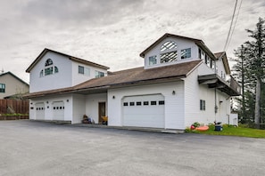 A two-story house with a garage, a front porch, and a driveway.