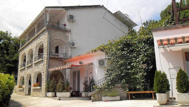 A two-story building with a stone facade, a balcony, and a red roof. - Sea View Apt With Terrace Kitchen (Opatija)