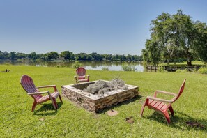 A lakeside view with a fire pit and Adirondack chairs. - Rural Lakefront Home - 17 Mi to Dtwn Livingston (Livingston)