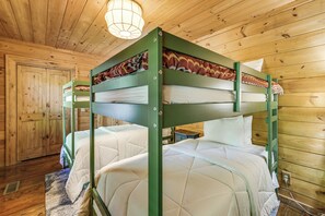 A bunk bed room with wooden walls and a ceiling light fixture. - Hot Tub + Fire Pit: Spacious Waynesville Escape! (Waynesville)