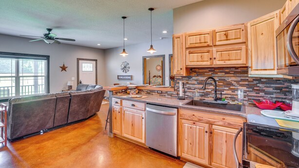 A spacious kitchen with wooden cabinets, a dishwasher, and a large island. - Boaters Base! 11 Mi to Kentucky & Barkley Lakes (Grand Rivers)