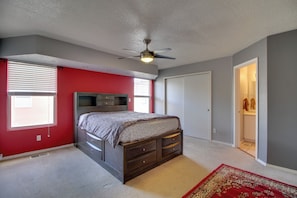 A bedroom with a bed, a ceiling fan, a window with blinds, a door, and a carpet. - Extended Stay w/ Hot Tub! 5 Mi to Old Town ABQ (Albuquerque)