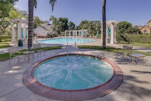A pool area with a hot tub, lounge chairs, and a pergola. - Fenced Yard! Family Escape, 1 Mi to Csub (Bakersfield)