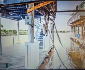 A bridge structure with a staircase leading up to a building.
