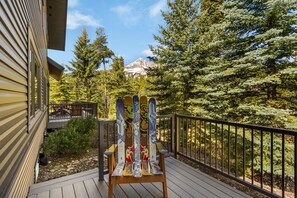 A deck with a chair, a railing, and a view of a mountain. - 3BR Ski-In/Out Condo, Nordic Trails, Free Shuttle Access – Big Sky, MT (Big Sky)