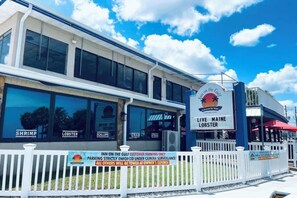 A restaurant with a sign indicating it serves live Maine lobster and shrimp. - The Gulf Oasis-
 Pool, hot tub, boat ramp, floating dock, kayaks, waterfront (Hudson)