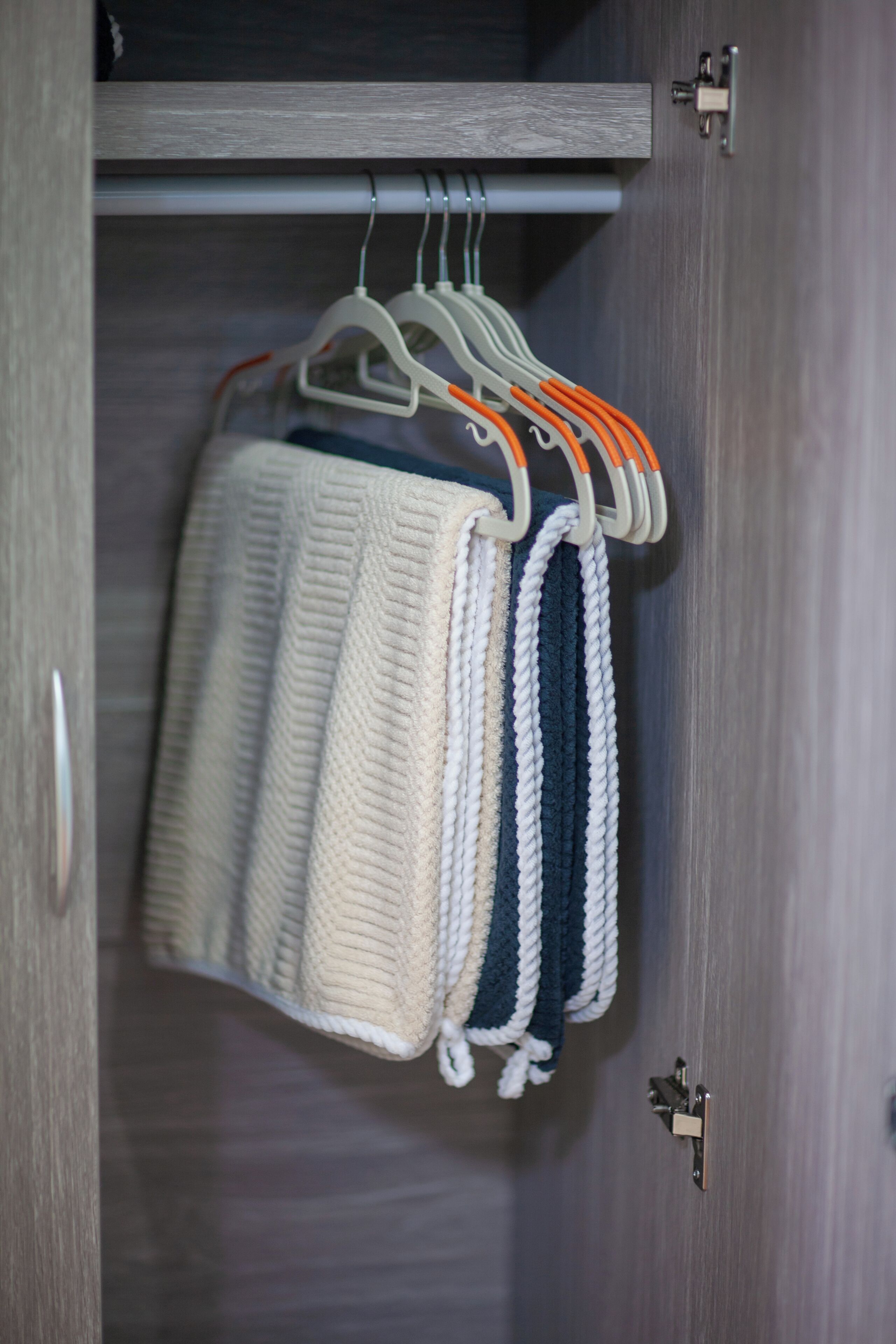 A wardrobe with a hanging rack holding several garments.