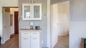Un interior moderno con un armario de madera, una radio y una decoración con forma de corazón en la pared.