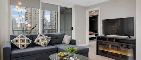 Departamento Deluxe, vista a la ciudad | Área de sala de estar