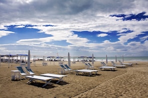 A beach with sun loungers and umbrellas, a clear sky, and the ocean in the background. - Casa Colombo With Garden In Forte Dei Marmi (Forte dei Marmi)